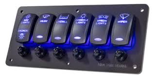 Illuminated marine switch panel with six labeled rocker switches and blue LED backlighting